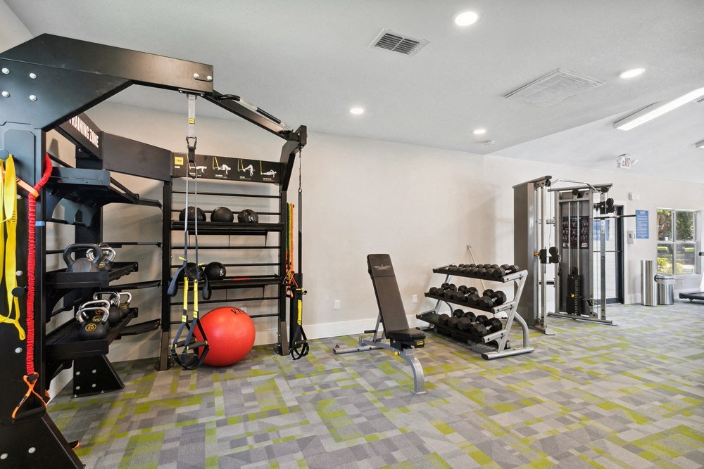 Fitness center with weights at Retreat at Crosstown Apartments