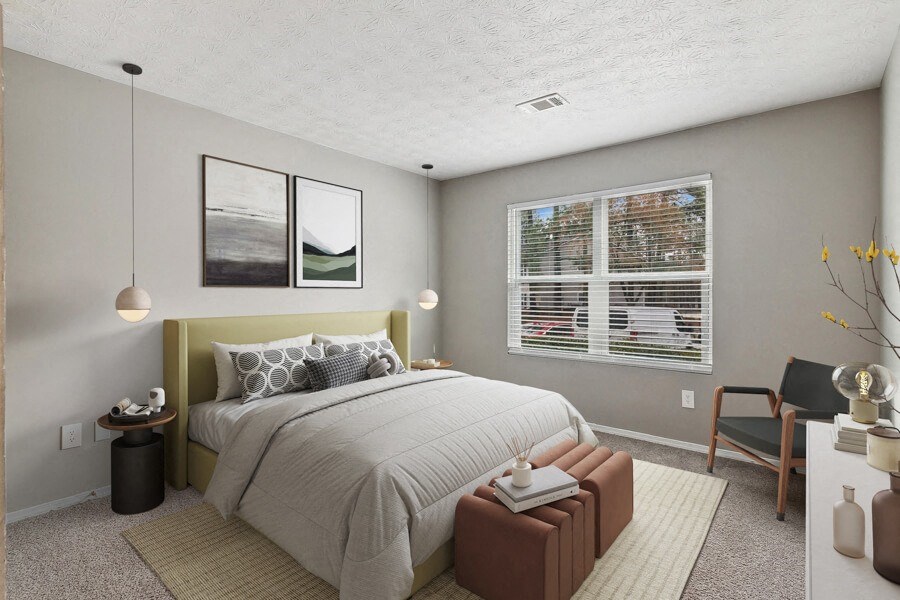 a bedroom with a bed and a large window