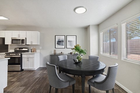 a kitchen and dining room with a table and chairs