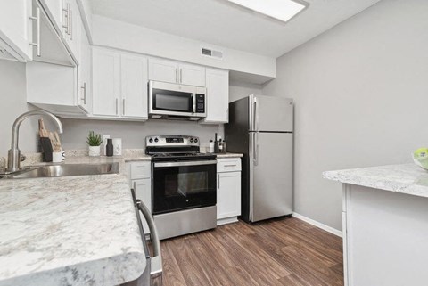 a kitchen with stainless steel appliances and white cabinets