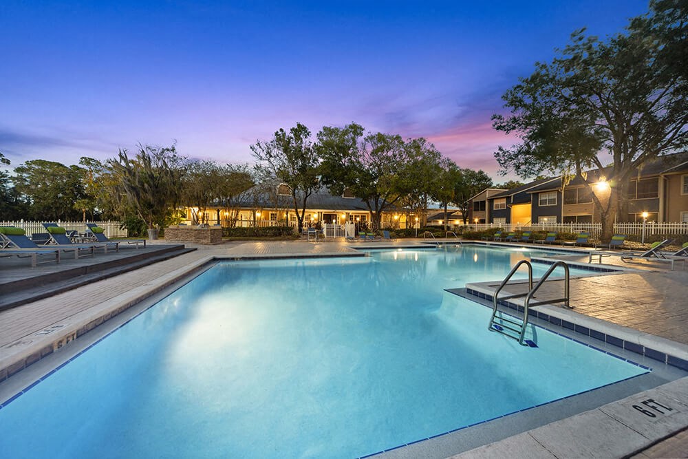 Community Swimming Pool with Pool Furniture at Walden Lake Apartments in Plant City, FL.