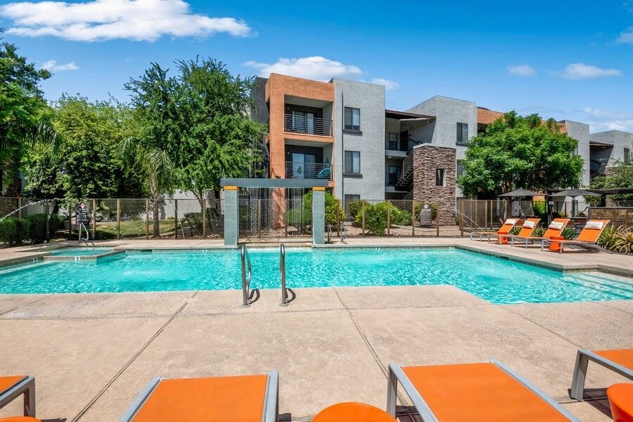 Community Swimming Pool with Pool Furniture at Harmony at Surprise Apartments in Surprise, AZ.