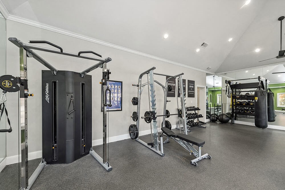 Community Fitness Center with Equipment at Bridges at Oakbend Apartments in Lewisville, TX.