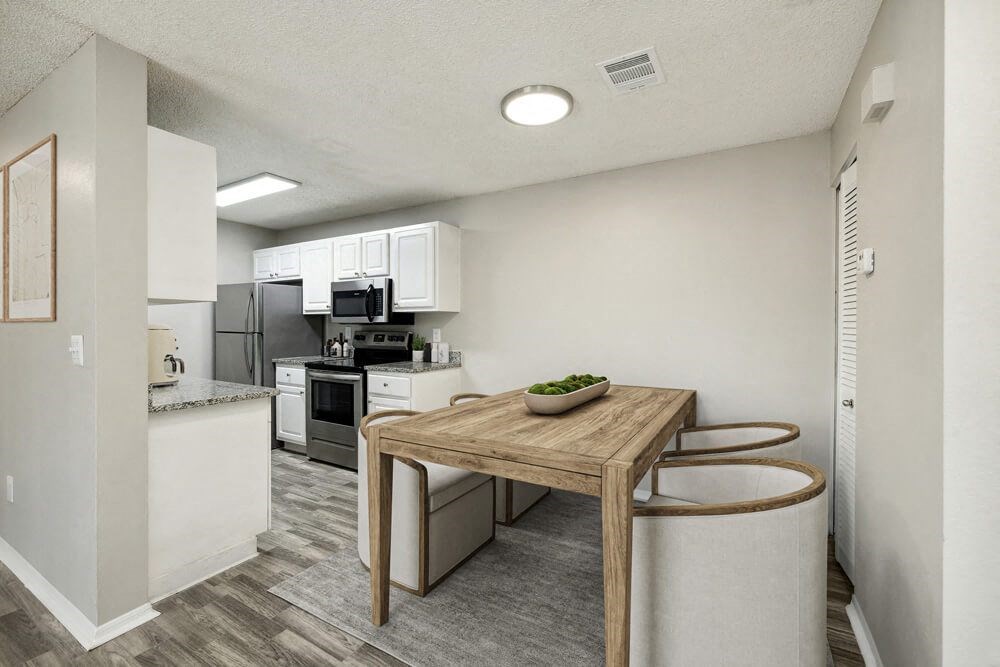 Model kitchen with a wooden table and two stools