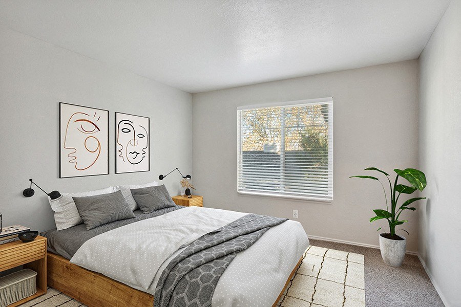 Model Bedroom with Carpet and Window View at Broadmoor Village Apartments in Salt Lake City, UT.