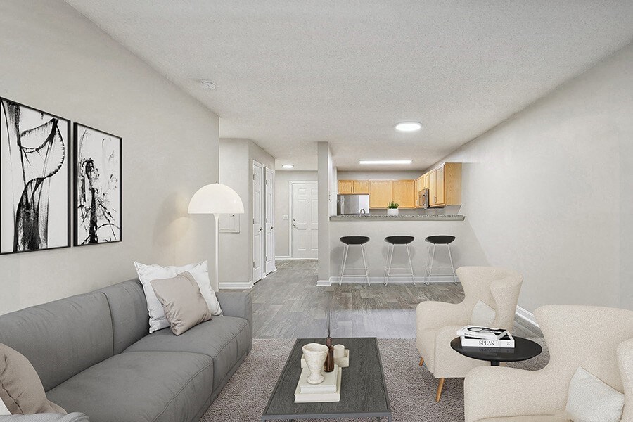 Model Living Room with Carpet and View of Kitchen at Retreat at Stonecrest Apartments located in Lithonia, GA.