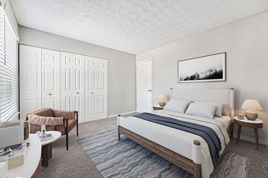 Model Bedroom with Carpet and Double Closets at Paramont Apartments in Duluth, GA.