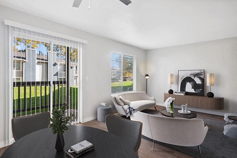 Model Dining/Living Room with Wood-Style Flooring and Patio Accessibility at Overlook Point Apartments in Salt Lake City, UT.