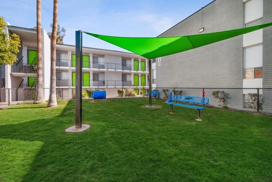 Fenced in dog park with sun cover