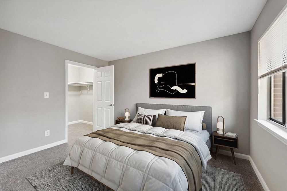Model Bedroom with Carpet and Walk In Closet at Spring Forest Apartments in Raleigh, NC.