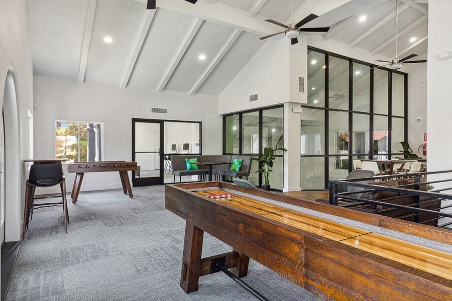 Community Clubhouse with Game Tables and Lounge Furniture at Meadow Ridge Apartments located in Las Vegas, NV.