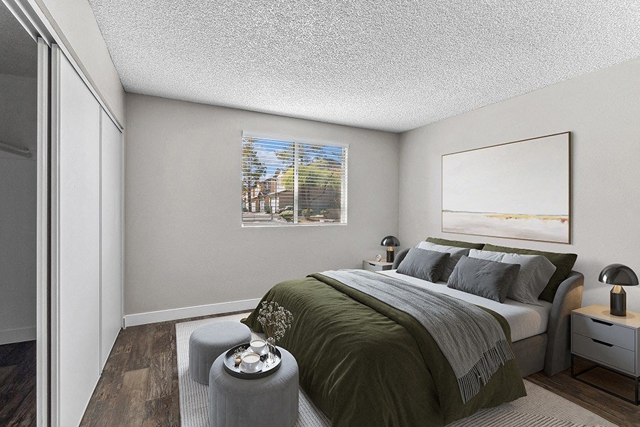 Model Bedroom with Wood-Style Flooring at Meadow Ridge Apartments in Las Vegas, NV.