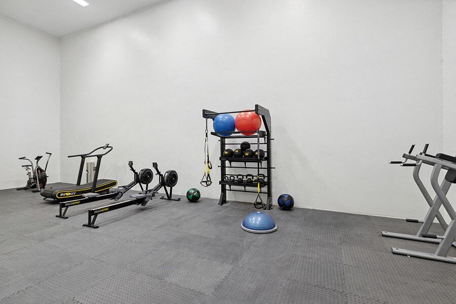Community Fitness Center with Equipment at Hilands Apartments in Tucson, AZ.