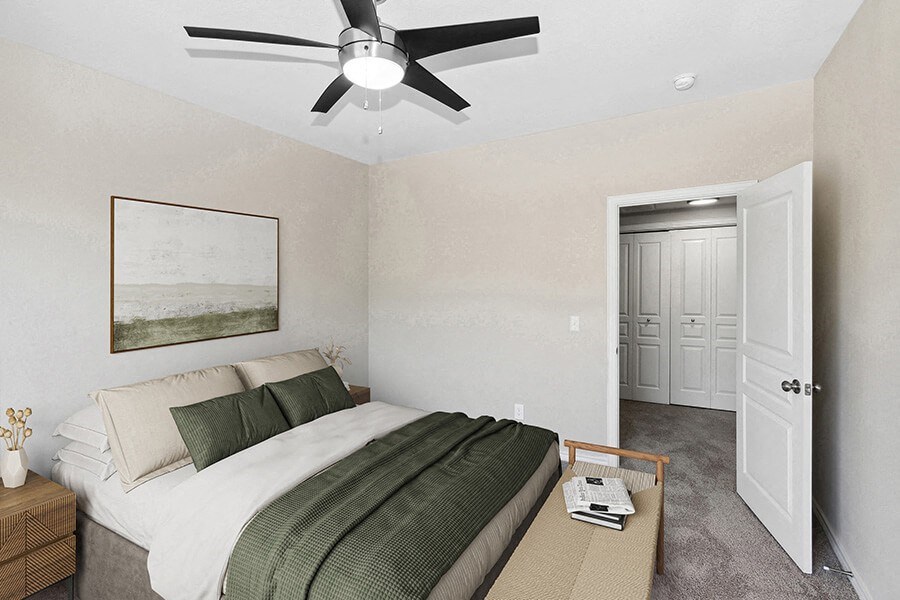 Model Bedroom with Carpet and Hallway View at Belmont at Duck Creek Apartments in Garland, TX.