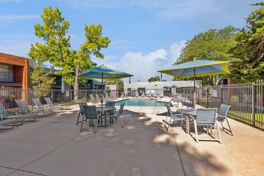 Community Swimming Pool with Pool Furniture at Indigo Park Apartments in Albuquerque, NM.