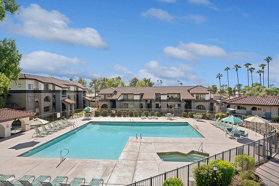 Community Swimming Pool with Pool Furniture at Stillwater Apartments located in Glendale, AZ.