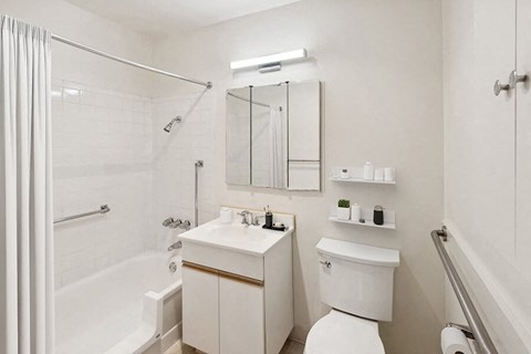 Model Bathroom with White Cabinets, Wood-Style Flooring & Shower/Tub at Walnut Creek Apartments located in Walnut Creek, CA.