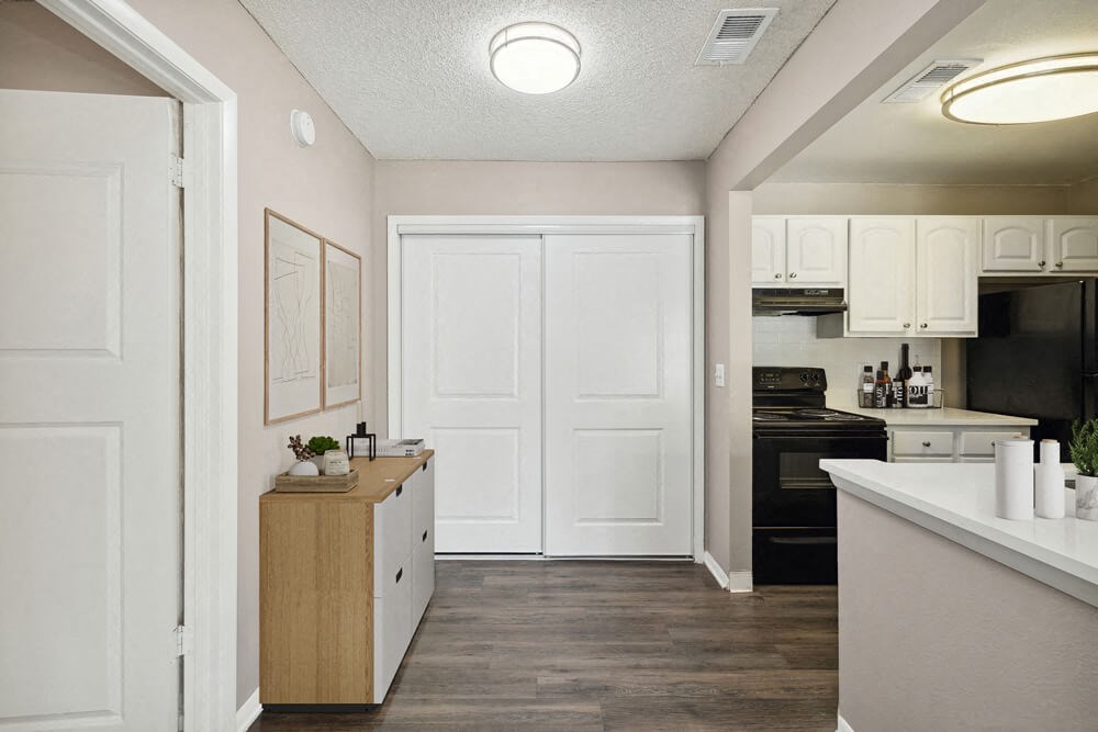 Model kitchen with white cabinets and black appliances at Vue at Baymeadows Apartments in Jacksonville, Florida