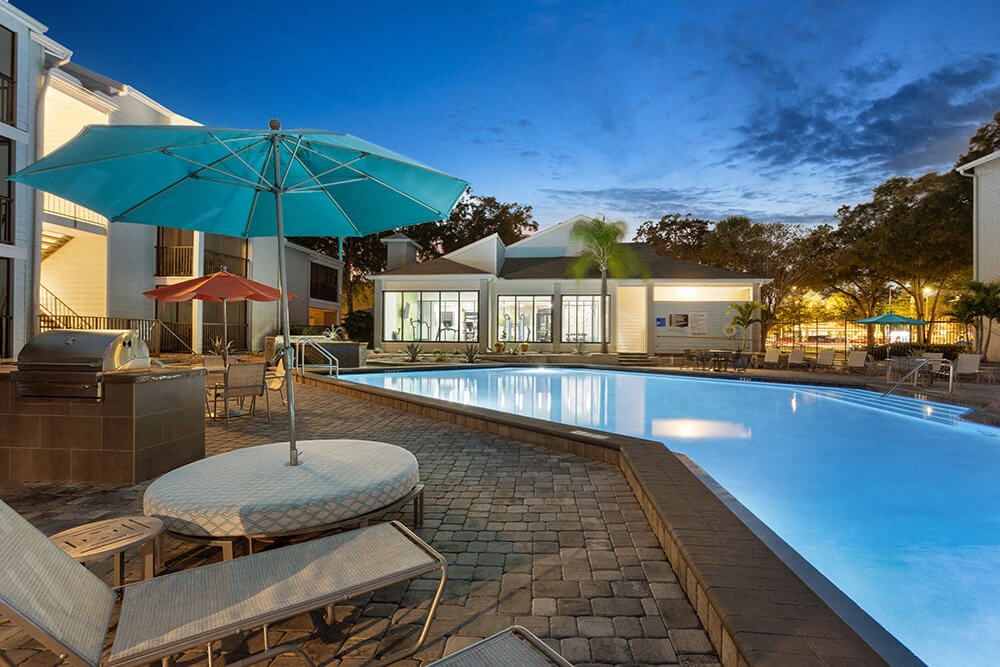 Community Swimming Pool with Pool Furniture at Haven at Water's Edge Apartments in Tampa, FL.