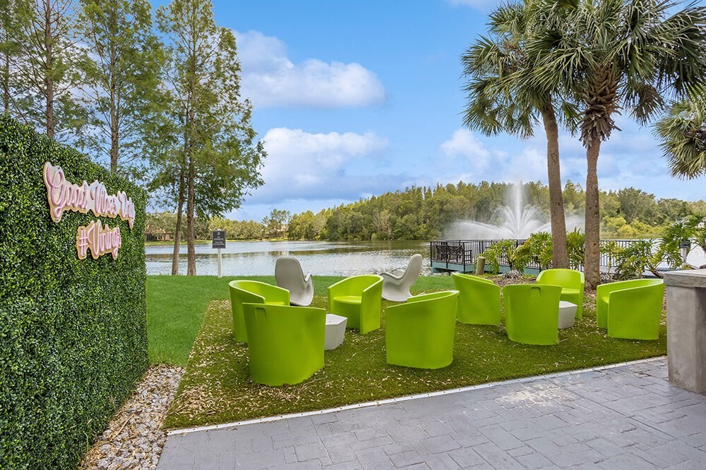 Outdoor lounge area with a fountain in the background and palm trees in the foreground