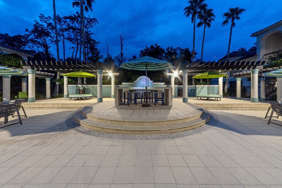 Community Patio Area with Lounge Furniture at Vinings at Hunter's Green Apartments in Tampa, FL.