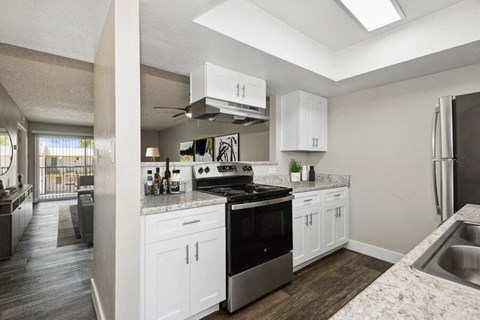 a kitchen with white cabinets and a black stove top oven