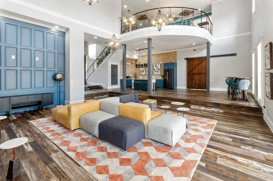 Clubhouse lounge area with couches and wood floors