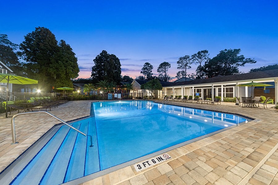 Community Swimming Pool with Pool Furniture at Retreat at Crosstown Apartments in Riverview, FL.