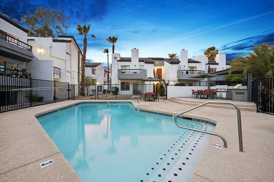 Community Swimming Pool with Pool Furniture at Crystal Creek Apartments in Phoenix, AZ.