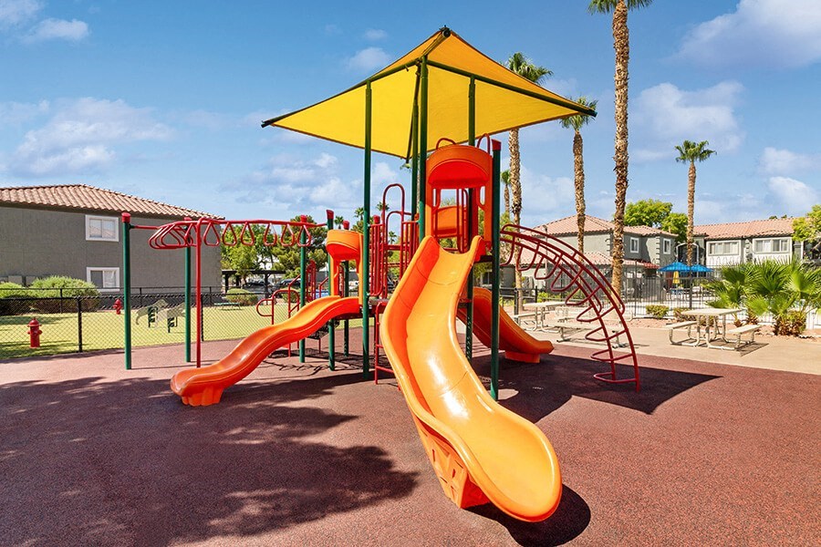 Community Playground with a Slide and Yellow Canopy at Loma Vista Apartments in Las Vegas, NV.