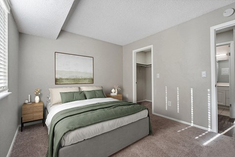 Model Bedroom with Carpet and attached Bathroom at Liberty Creek Apartments in Aurora, CO.