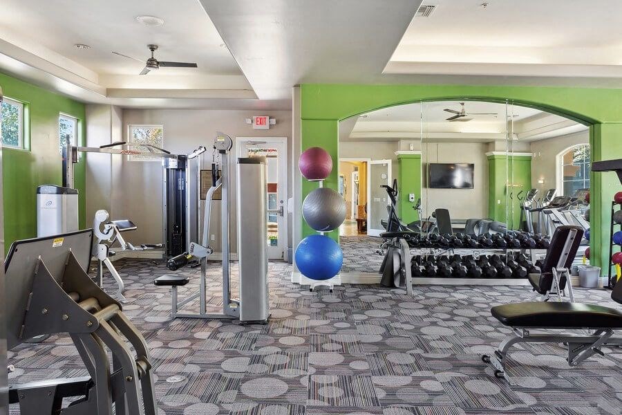 Fitness center with weight lifting equipment at Reserve at Rancho Apartments