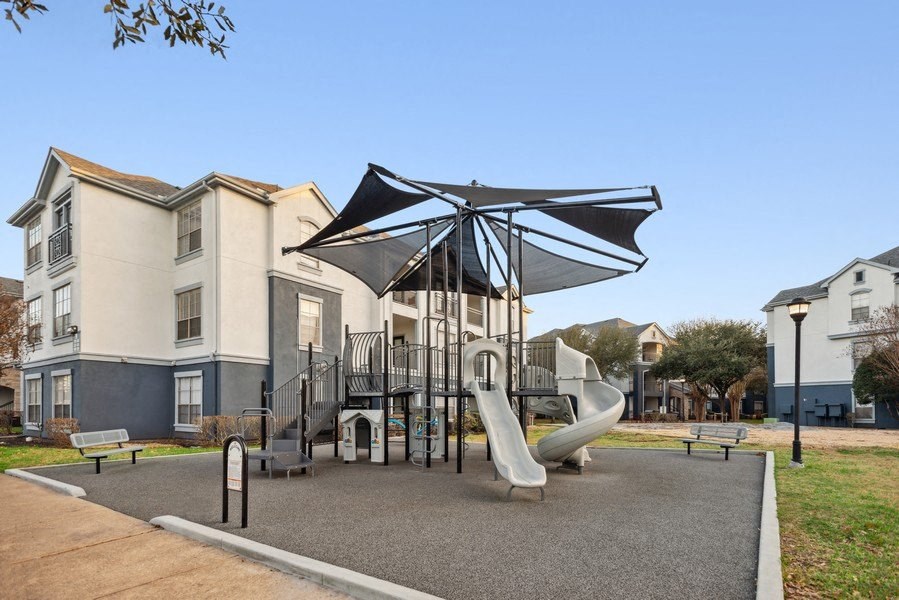 Community playground with sun cover at Park West Apartments in Houston, Texas