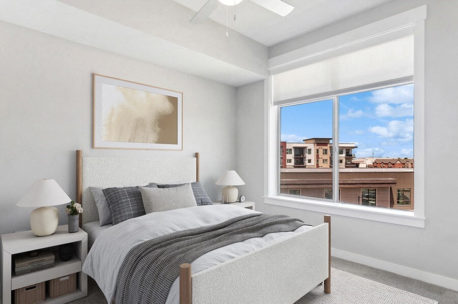 Model Bedroom with Carpet and Window View at Seven Skies Apartments located in Sandy, UT.