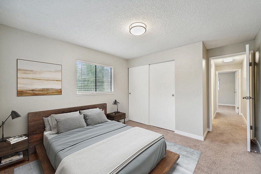 Model Bedroom with Carpet and Closet at Grammercy Apartments located in Renton, WA.