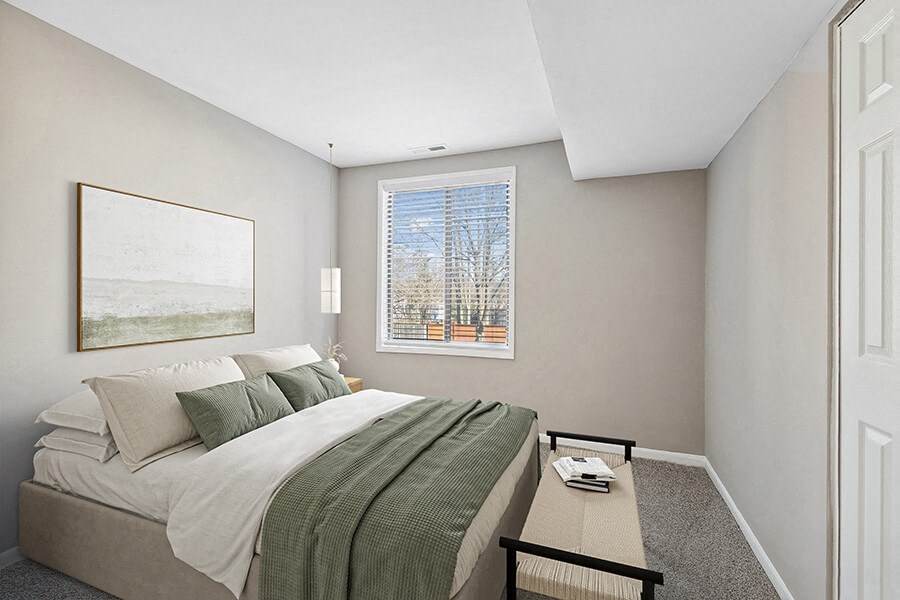 Model Bedroom with Carpet and Window View at Spring Parc Apartments in Silver Spring, MD.