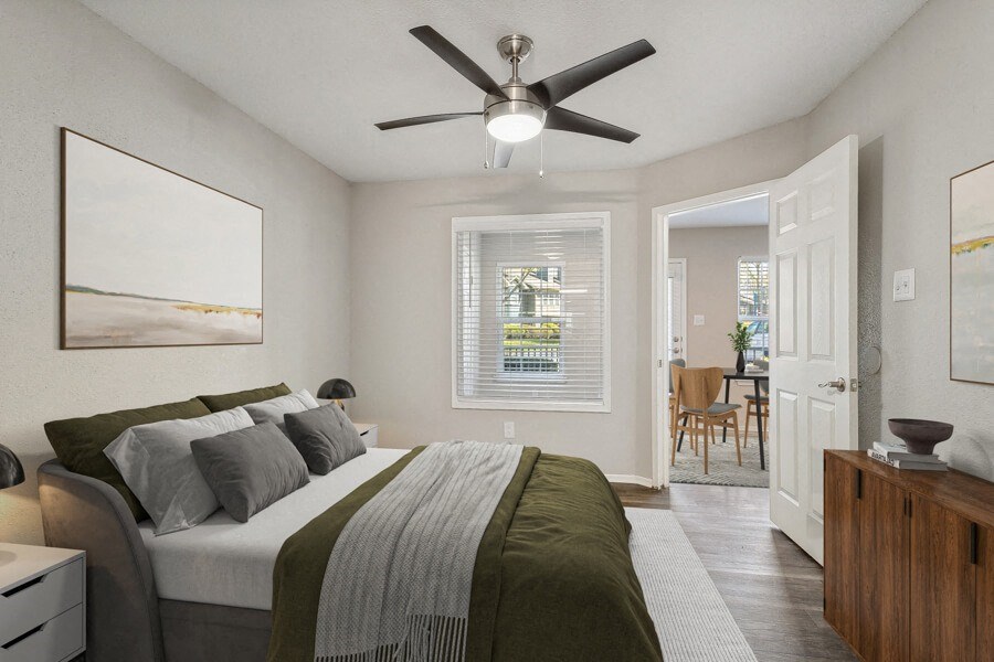 a bedroom with a large bed and a ceiling fan