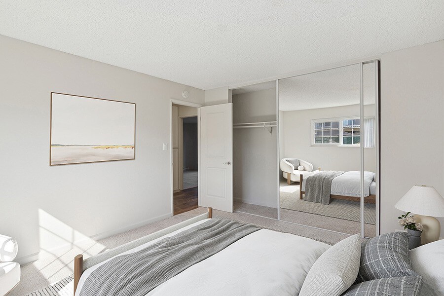 Model Bedroom with Carpet and Large Closet at Los Gatos Landing Apartments located in San Jose, CA.