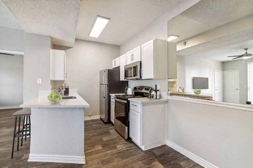 a kitchen with a stove top oven next to a refrigerator - Photo Gallery
