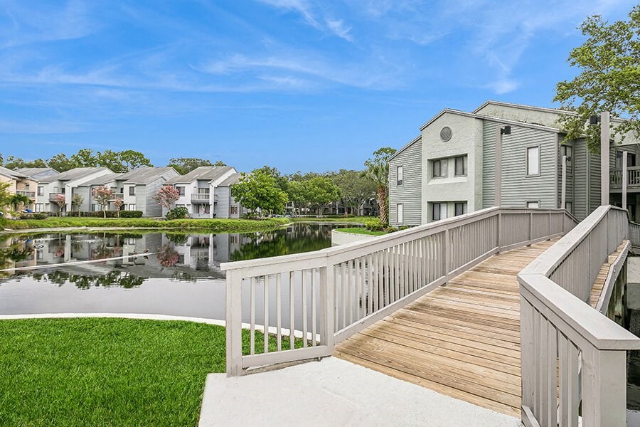 Community Pond and Walking Bridge at Huntington Place Apartments located in Sarasota, FL.