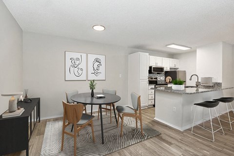 an open kitchen and dining area with a table and chairs