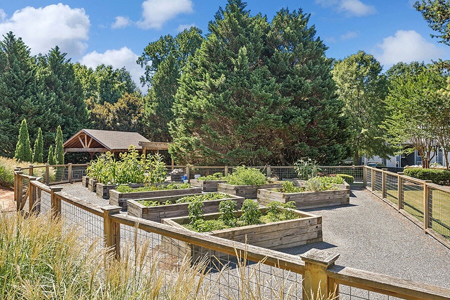 Community Garden with Planter Boxes at Lakeside Retreat Apartments located in Peachtree Corners, GA.