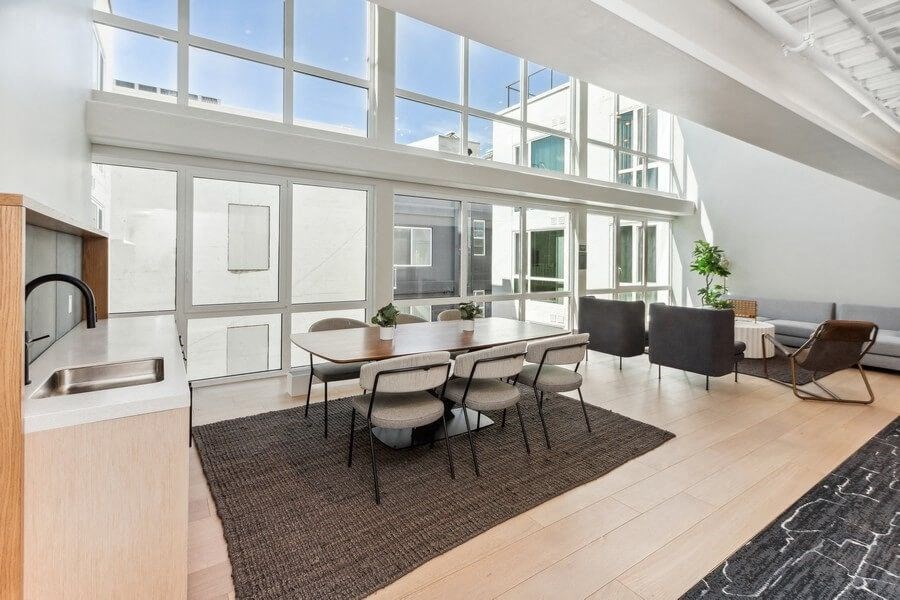 Community kitchen space with large sun windows at TL Residences