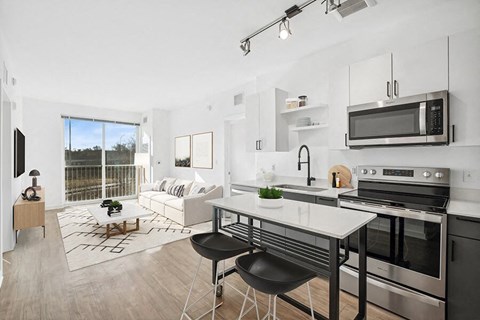 A modern kitchen with a dining table and chairs.