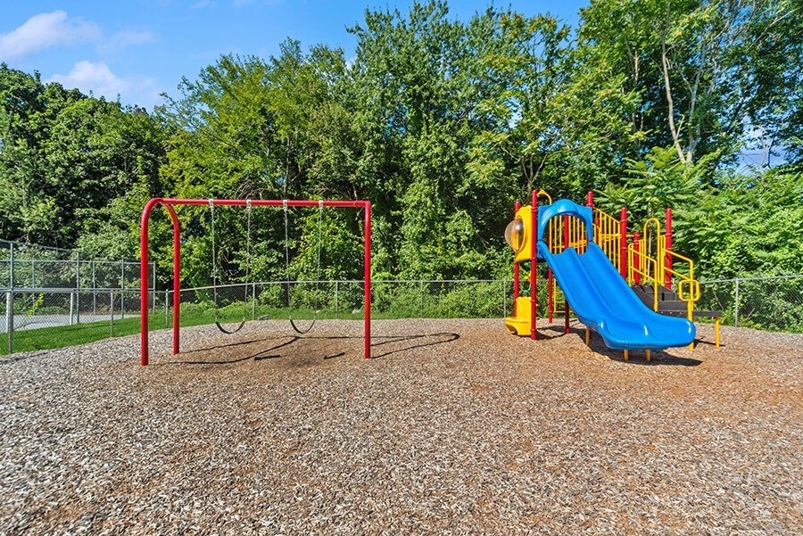 Community Playground with Slide and Swing Set at Heights Marlborough Apartments in Boston, MA.
