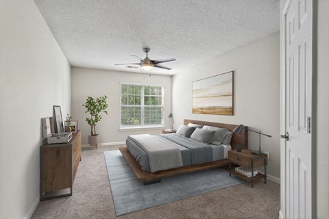 Model Bedroom with Carpet and Window View at Retreat at Stonecrest Apartments located in Lithonia, GA.