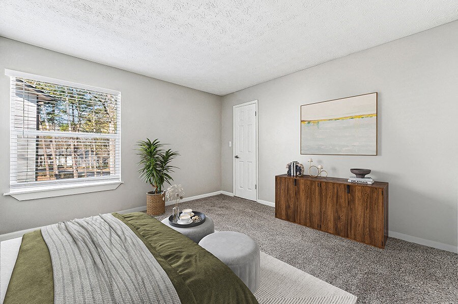 Model Bedroom with Carpet and Window View at Paramont Apartments in Duluth, GA.