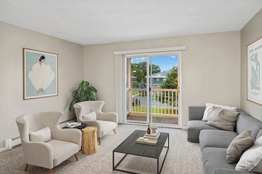 Model living room with a sliding glass door  at Stone Ends apartments in Stoughton, MA