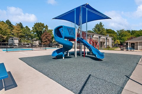 Community Playground with two Slides and Blue Canopy at Overlook Apartments located in Salt Lake City, UT.