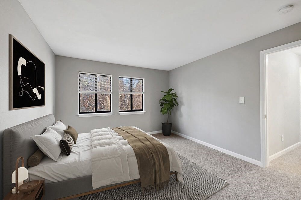 Model Bedroom with Carpet and Hallway View at Spring Forest Apartments in Raleigh, NC.